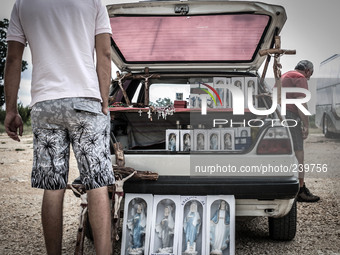 A man show on his car the Virgin Mary statues, rosaries, crucifixes for sell to tourist in Medjugorje. Almost one million people visit Medju...