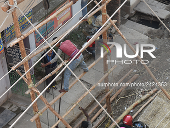 Labourers work at New Road contraction at howrah district ,around 16 kms West of Kolkata on January 15,2018 in Kolkata,India. (