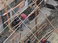 Labourers work at New Road contraction at howrah district ,around 16 kms West of Kolkata on January 15,2018 in Kolkata,India. (