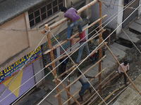 Labourers work at New Road contraction at howrah district ,around 16 kms West of Kolkata on January 15,2018 in Kolkata,India. (