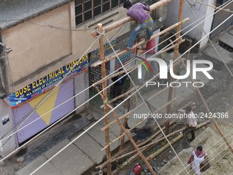 Labourers work at New Road contraction at howrah district ,around 16 kms West of Kolkata on January 15,2018 in Kolkata,India. (