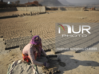 38 yrs old, KALIMAYA PARI making raw bricks at a brick factory in Lalitpur, Nepal on Tuesday, January 23, 2018. She used to make 600 - 700 b...