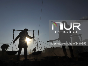 Migrant workers from India, carries mixed soil on a brick factory in Lalitpur, Nepal on Tuesday, January 23, 2018. (