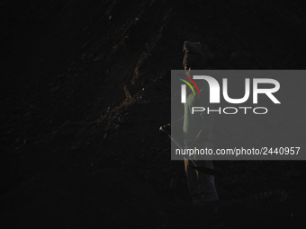 A Migrant worker from India, arrange coal to carry at a brick factory in Lalitpur, Nepal on Tuesday, January 23, 2018. (