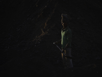 A Migrant worker from India, arrange coal to carry at a brick factory in Lalitpur, Nepal on Tuesday, January 23, 2018. (