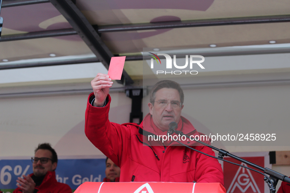 Jürgen Wechsler showing the red card taking part in a strike at a BMW factory site in Munich, Germany, 2 February 2017. A few thousand came...