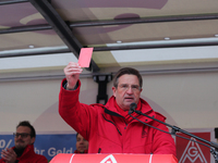 Jürgen Wechsler showing the red card taking part in a strike at a BMW factory site in Munich, Germany, 2 February 2017. A few thousand came...