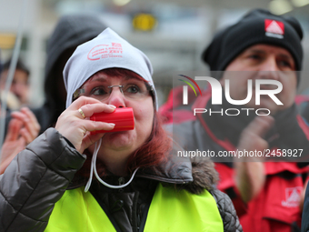 Striking worker blowing the whistle taking part in a strike at a BMW factory site in Munich, Germany, 2 February 2017. A few thousand came t...