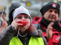 Striking worker blowing the whistle taking part in a strike at a BMW factory site in Munich, Germany, 2 February 2017. A few thousand came t...