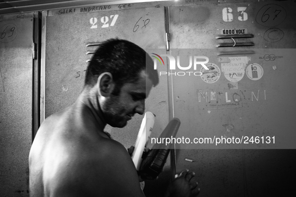 Italy, Sardinia 2013 A miner in front his clock room after his shift of work. 