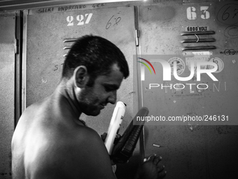 Italy, Sardinia 2013 A miner in front his clock room after his shift of work. (