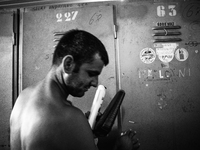 Italy, Sardinia 2013 A miner in front his clock room after his shift of work. (