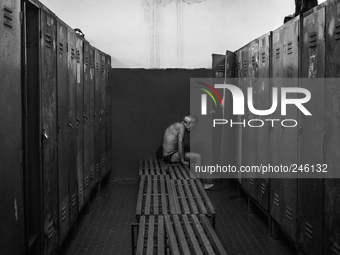  Italy, Sardinia 2013 A old miner sitting in front of his clock room after a long day of work (