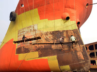 Painters paint on a long ship at Keraniganj, Dhaka, Bangladesh on 18 February 2018. When it comes to shipping, Bangladesh is known mostly as...