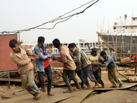 Some of worker pulling the heavy parts of a ship at Keraniganj, Dhaka, Bangladesh on 18 February 2018. When it comes to shipping, Bangladesh...