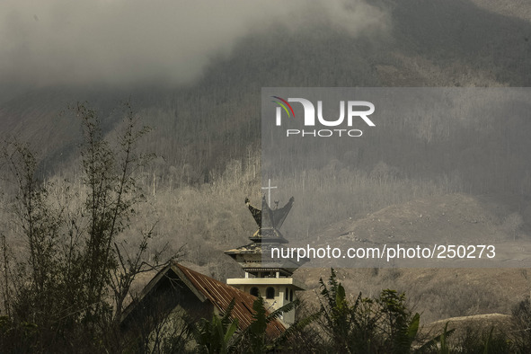 Photo taken on Sept. 13, 2014
A Church abandoned as Mount Sinabung is seen on the background in Sukanalu village, At Karo, North Sumatra, In...