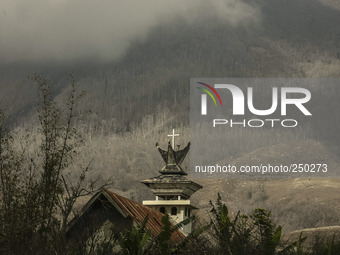 Photo taken on Sept. 13, 2014
A Church abandoned as Mount Sinabung is seen on the background in Sukanalu village, At Karo, North Sumatra, In...