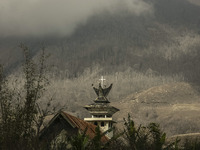 Photo taken on Sept. 13, 2014
A Church abandoned as Mount Sinabung is seen on the background in Sukanalu village, At Karo, North Sumatra, In...