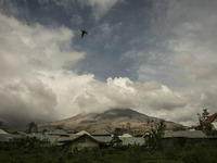 Photo taken on Sept. 13, 2014
A village abandoned as Mount Sinabung is seen on the background in Sukanalu village, At Karo, North Sumatra, I...