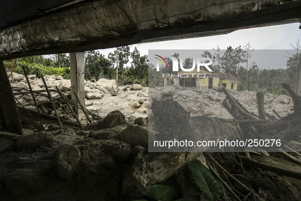 An empty house is seen surrounded by volcanic material in Guru Kinayan village, North Sumatra, Indonesia, on Sept. 13, 2014. The volcano Mou...