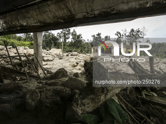 An empty house is seen surrounded by volcanic material in Guru Kinayan village, North Sumatra, Indonesia, on Sept. 13, 2014. The volcano Mou...