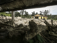 An empty house is seen surrounded by volcanic material in Guru Kinayan village, North Sumatra, Indonesia, on Sept. 13, 2014. The volcano Mou...