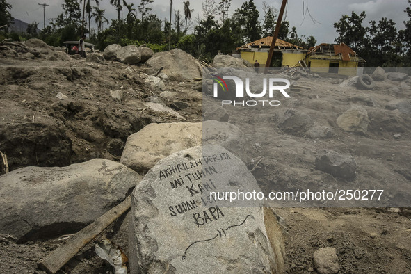 An empty house is seen surrounded by volcanic material in Guru Kinayan village, North Sumatra, Indonesia, on Sept. 13, 2014. The volcano Mou...