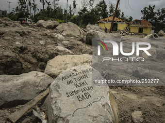 An empty house is seen surrounded by volcanic material in Guru Kinayan village, North Sumatra, Indonesia, on Sept. 13, 2014. The volcano Mou...