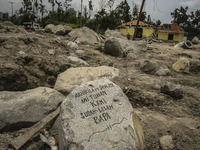 An empty house is seen surrounded by volcanic material in Guru Kinayan village, North Sumatra, Indonesia, on Sept. 13, 2014. The volcano Mou...