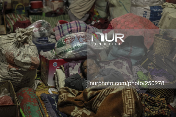 A woman sleep in a refugee camp at Kabanjahe, North Sumatra, Indonesia, on Sept. 11, 2014. The volcano Mount Sinabung has erupted intermitte...