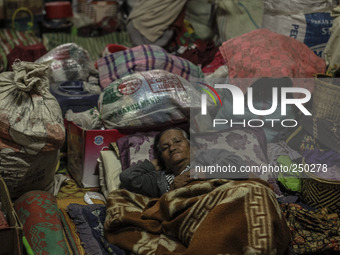 A woman sleep in a refugee camp at Kabanjahe, North Sumatra, Indonesia, on Sept. 11, 2014. The volcano Mount Sinabung has erupted intermitte...