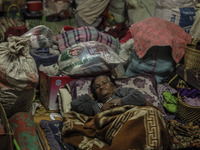 A woman sleep in a refugee camp at Kabanjahe, North Sumatra, Indonesia, on Sept. 11, 2014. The volcano Mount Sinabung has erupted intermitte...