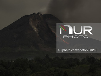 The slow shutter speed photo taken on Sept. 12, 2014 shows lava flowing out of Mount Sinabung as seen from Tiga Pancur village, North Sumatr...