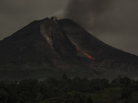 The slow shutter speed photo taken on Sept. 12, 2014 shows lava flowing out of Mount Sinabung as seen from Tiga Pancur village, North Sumatr...