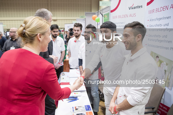 Mayor of Neukoelln Franzisk Giffey (L) visits the stand of Vivantes group during a Job Fair for Refugees and Migrants in Berlin, Germany on...