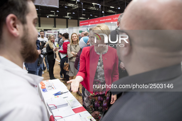 Mayor of Neukoelln Franzisk Giffey (C) visits the stand of Vivantes group during a Job Fair for Refugees and Migrants in Berlin, Germany on...