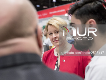 Mayor of Neukoelln Franzisk Giffey (C) visits the stand of Vivantes group during a Job Fair for Refugees and Migrants in Berlin, Germany on...