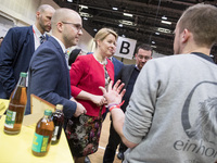 Mayor of Neukoelln Franzisk Giffey (C) visits the stand of Solidrinks during a Job Fair for Refugees and Migrants in Berlin, Germany on Febr...