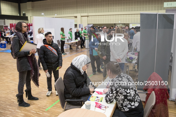 People attend a Job Fair for Refugees and Migrants in Berlin, Germany on February 20, 2018. With over 200 exhibitors and around 3000 job off...