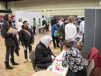 People attend a Job Fair for Refugees and Migrants in Berlin, Germany on February 20, 2018. With over 200 exhibitors and around 3000 job off...