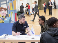 People attend a Job Fair for Refugees and Migrants in Berlin, Germany on February 20, 2018. With over 200 exhibitors and around 3000 job off...