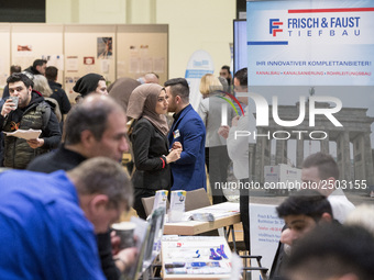 People attend a Job Fair for Refugees and Migrants in Berlin, Germany on February 20, 2018. With over 200 exhibitors and around 3000 job off...