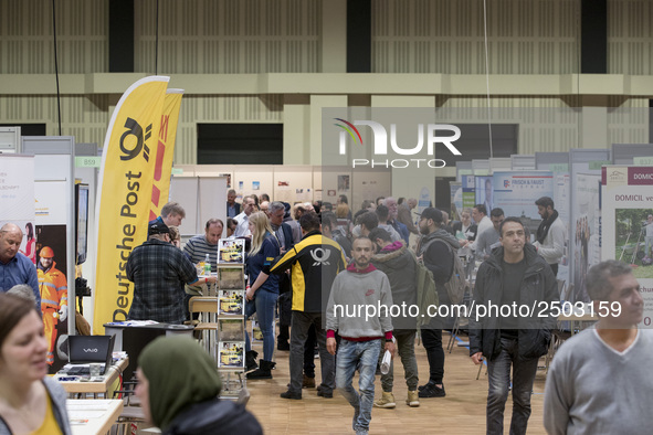 People attend a Job Fair for Refugees and Migrants in Berlin, Germany on February 20, 2018. With over 200 exhibitors and around 3000 job off...