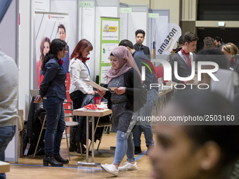 People attend a Job Fair for Refugees and Migrants in Berlin, Germany on February 20, 2018. With over 200 exhibitors and around 3000 job off...