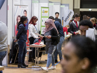 People attend a Job Fair for Refugees and Migrants in Berlin, Germany on February 20, 2018. With over 200 exhibitors and around 3000 job off...