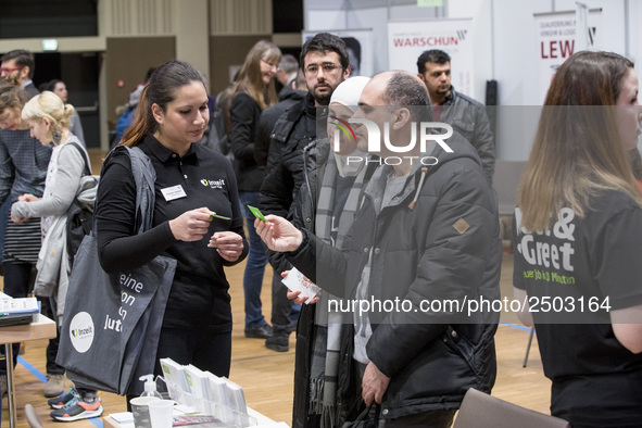 People attend a Job Fair for Refugees and Migrants in Berlin, Germany on February 20, 2018. With over 200 exhibitors and around 3000 job off...