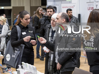 People attend a Job Fair for Refugees and Migrants in Berlin, Germany on February 20, 2018. With over 200 exhibitors and around 3000 job off...