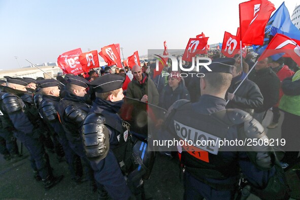 Striking Air France employees walk with union flags, followed by a groupf of French CRS anti-riot police, outside Charles de Gaulle airport...