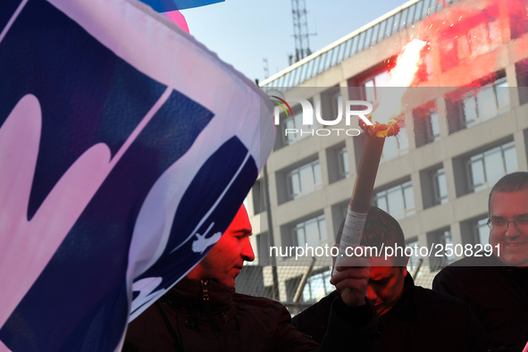 Striking Air France employees burn flares as they march at Charles de Gaulle airport in Roissy, outside Paris, on February 22, 2018. Half of...