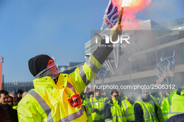 Striking Air France employees burn flares as they march at Charles de Gaulle airport in Roissy, outside Paris, on February 22, 2018. Half of...